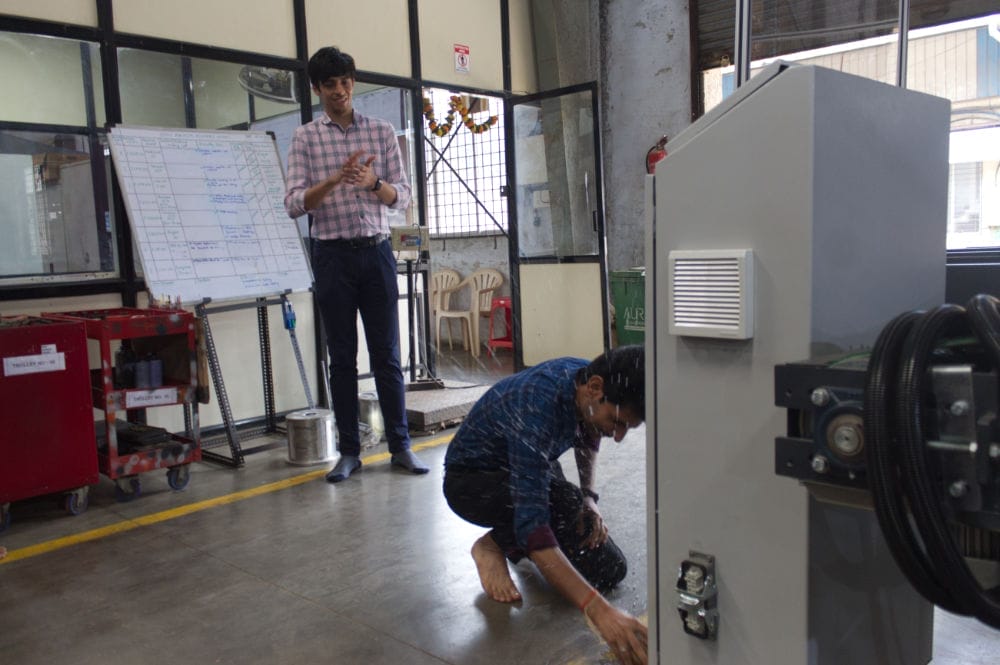 Two men working in a factory setting.