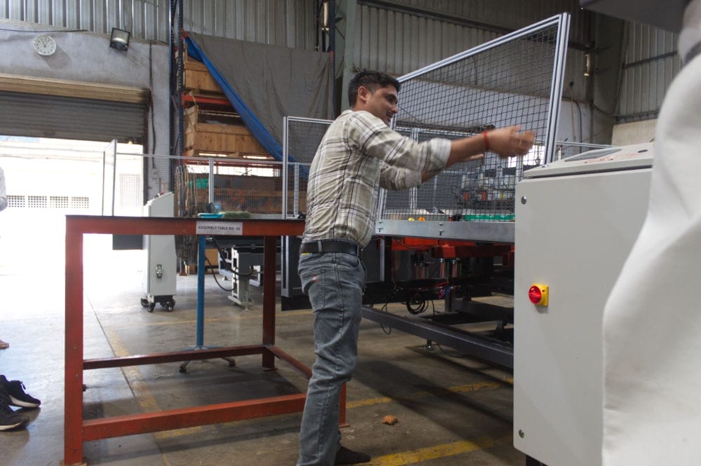 Worker operating industrial machinery in factory