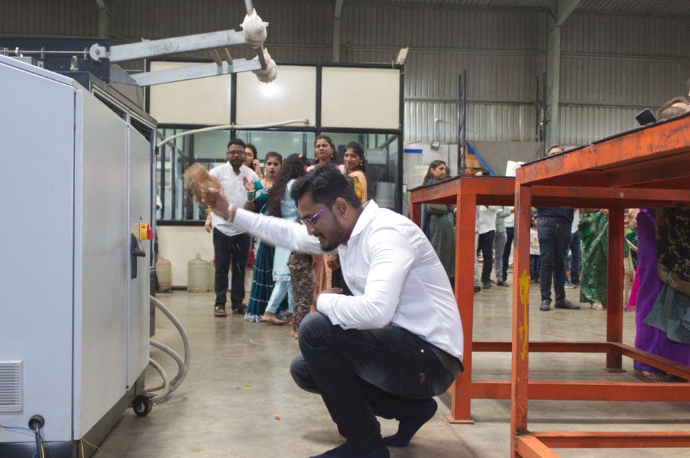 Man performing ritual in industrial setting.