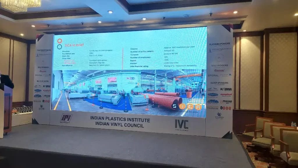 Conference presentation on plastic pipe manufacturing.