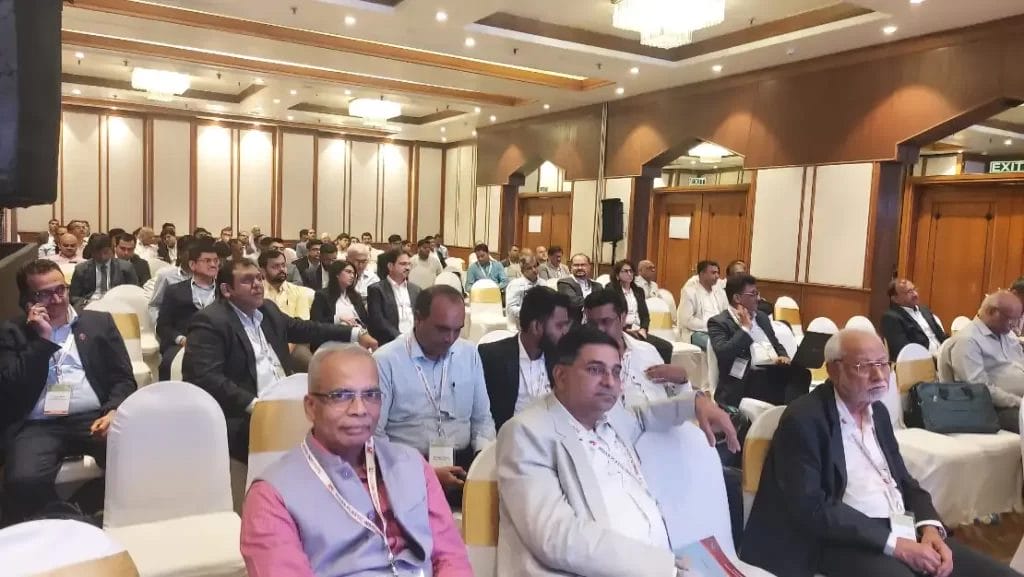 Audience attentively listening at conference event.