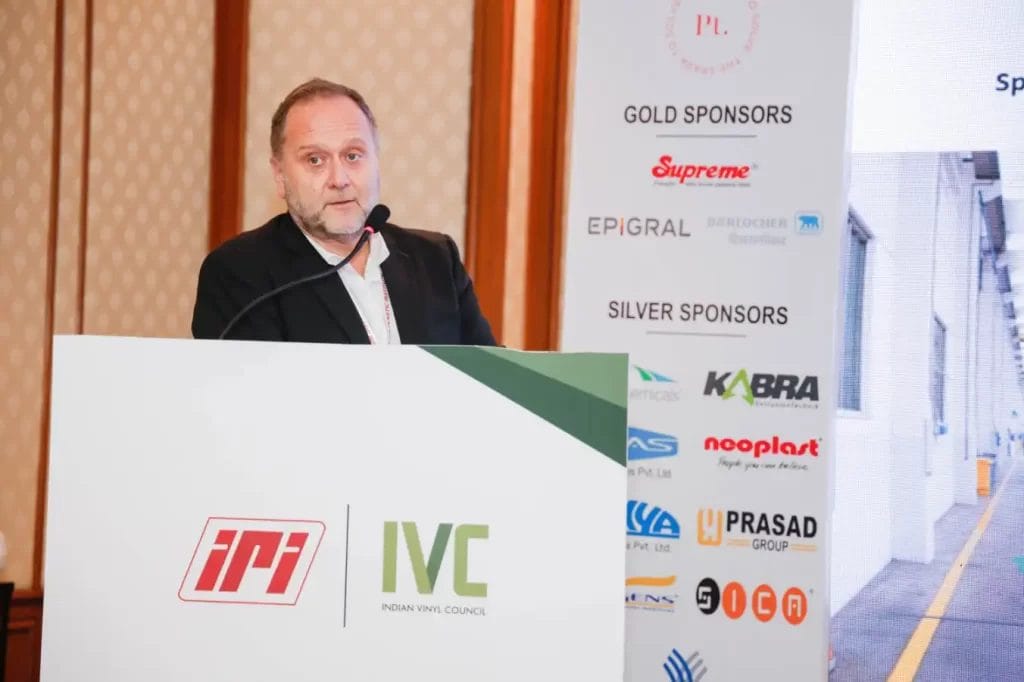 Speaker at Indian Vinyl Council conference podium.
