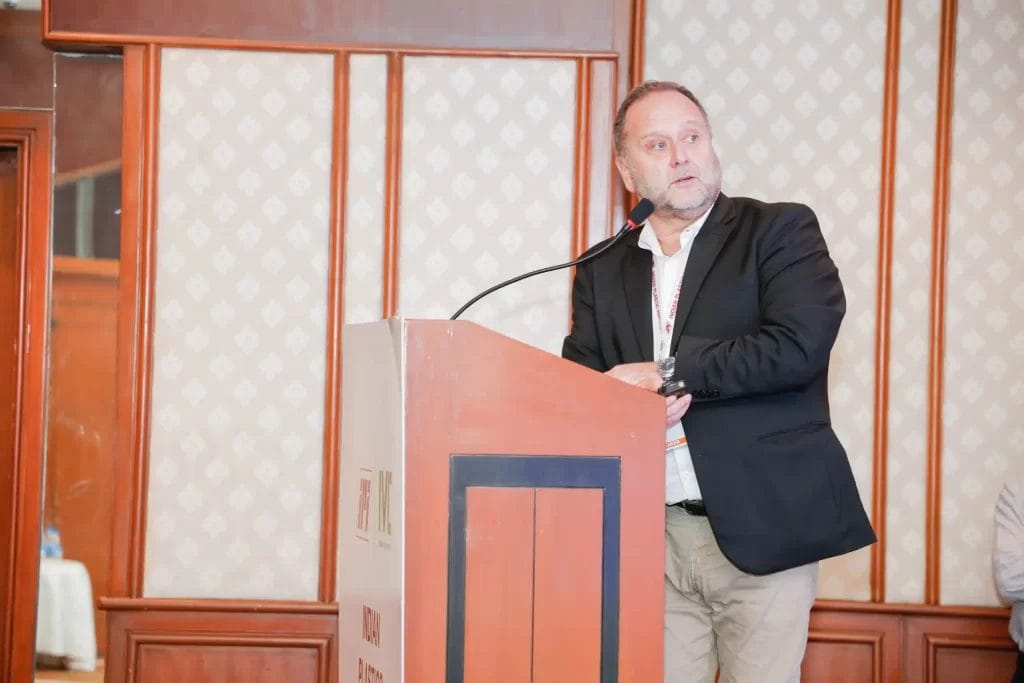 Man speaking at a conference podium