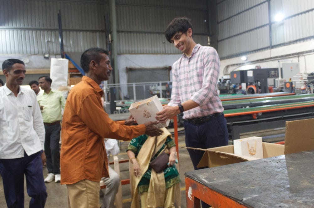 Man giving gift in factory setting