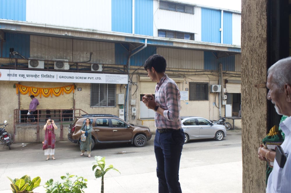 People outside an industrial building in India.